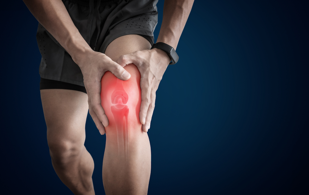 man suffering a knee pain from overuse