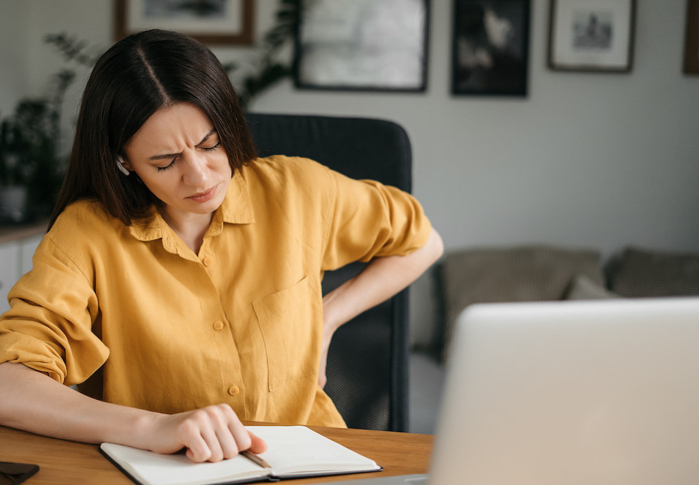woman suffering a back pain from poor posture